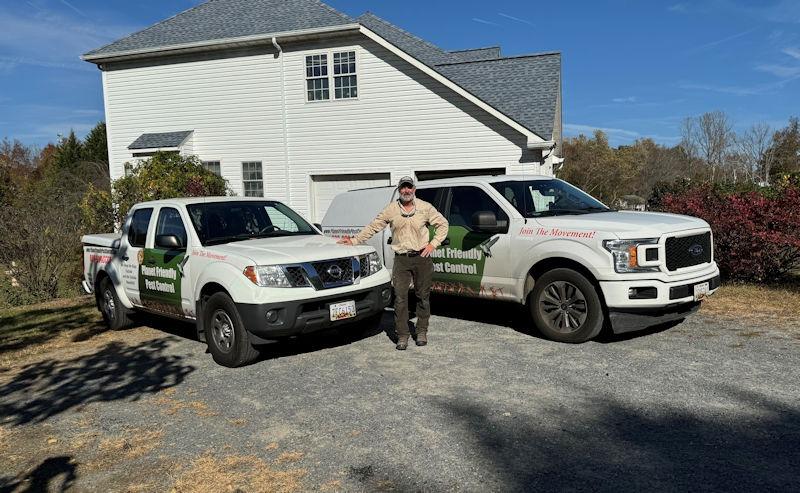 Gene Wright, owner of Planet Friendly Pest Control, with the company trucks