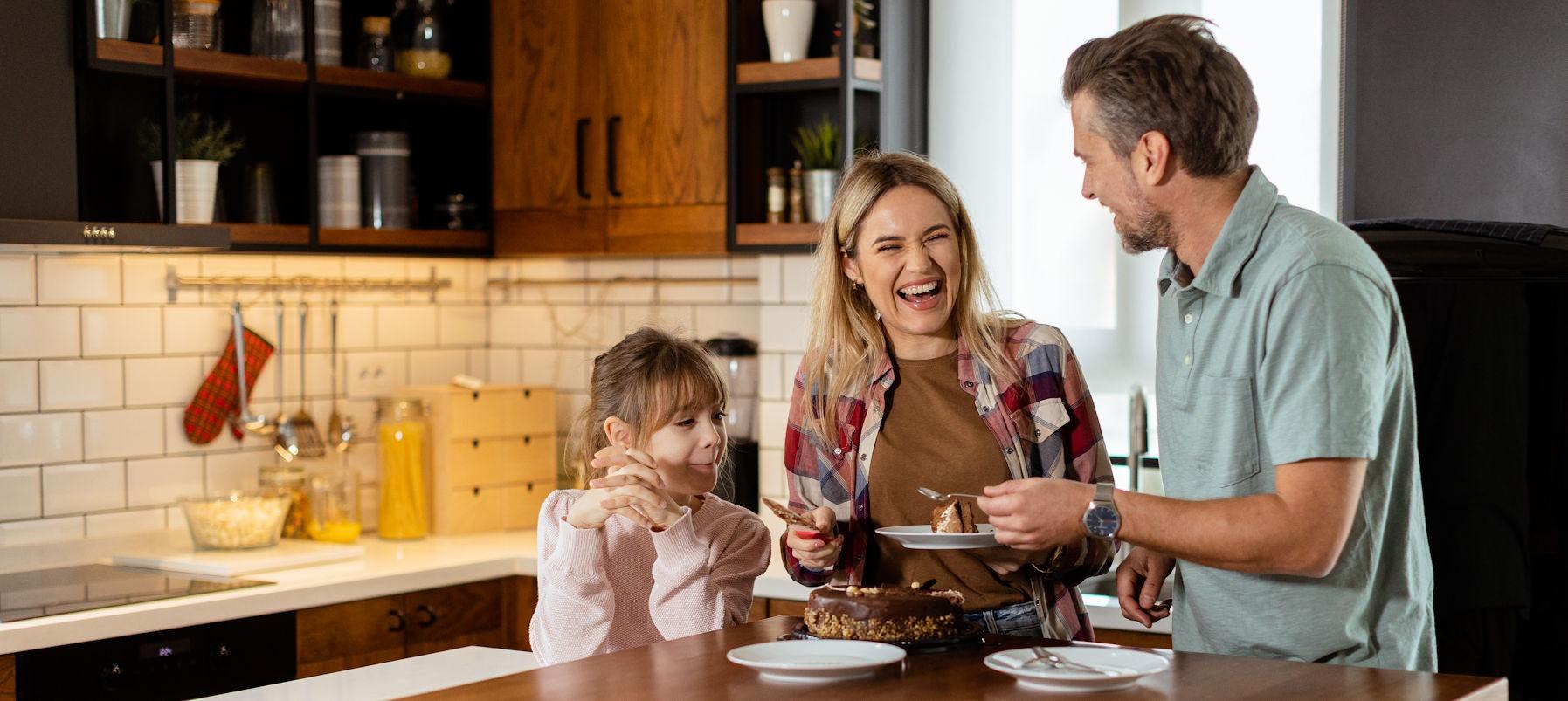 A happy family enjoying dessert together in their kitchen