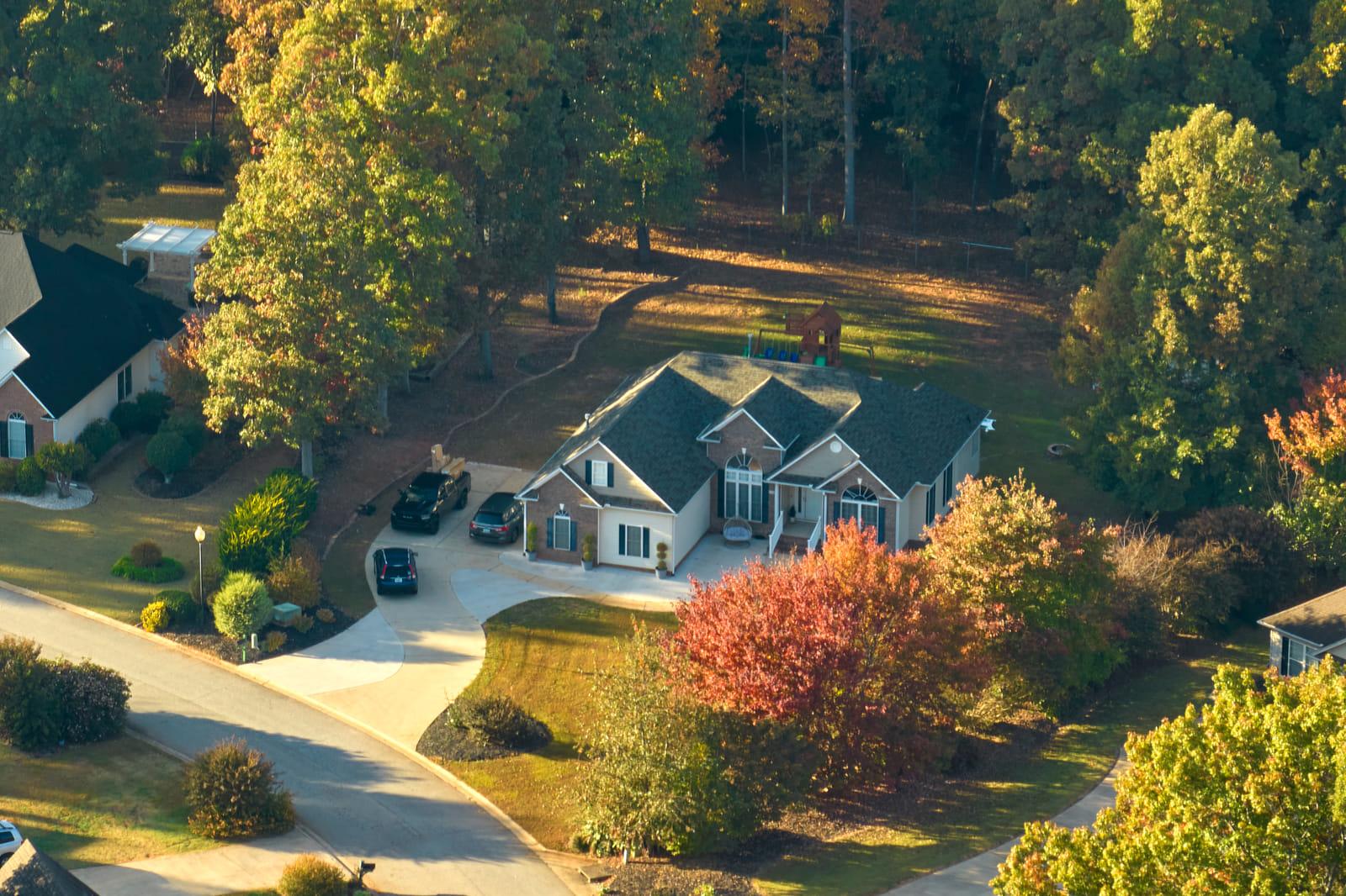 Mulch beds and shrubbery along the brick foundation of an Alexandria home