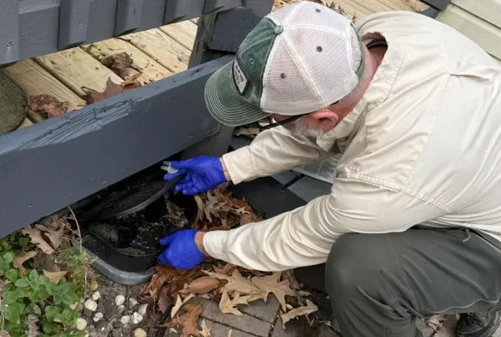A Planet Friendly Pest Control technician treating a home's exterior perimeter