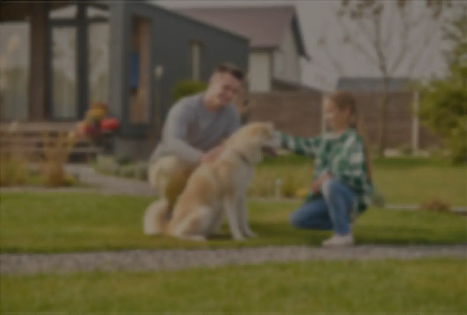 A homeowner and their dog in front of their house